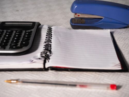 Stock Profit Calculator Notepad paper in office with calculator