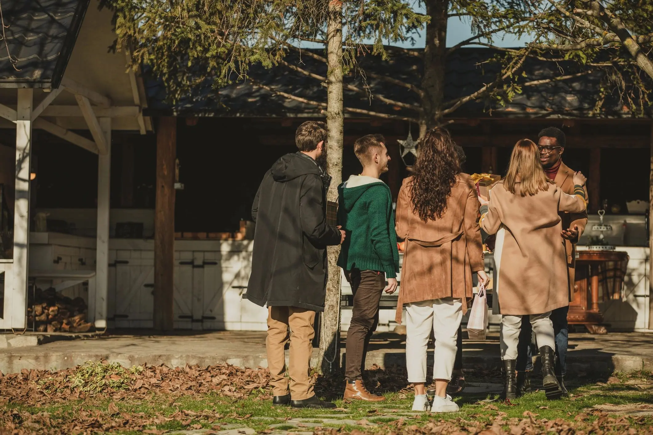 Life Insurance Quote Wide shot of friends greeting with their hosts upon arrival