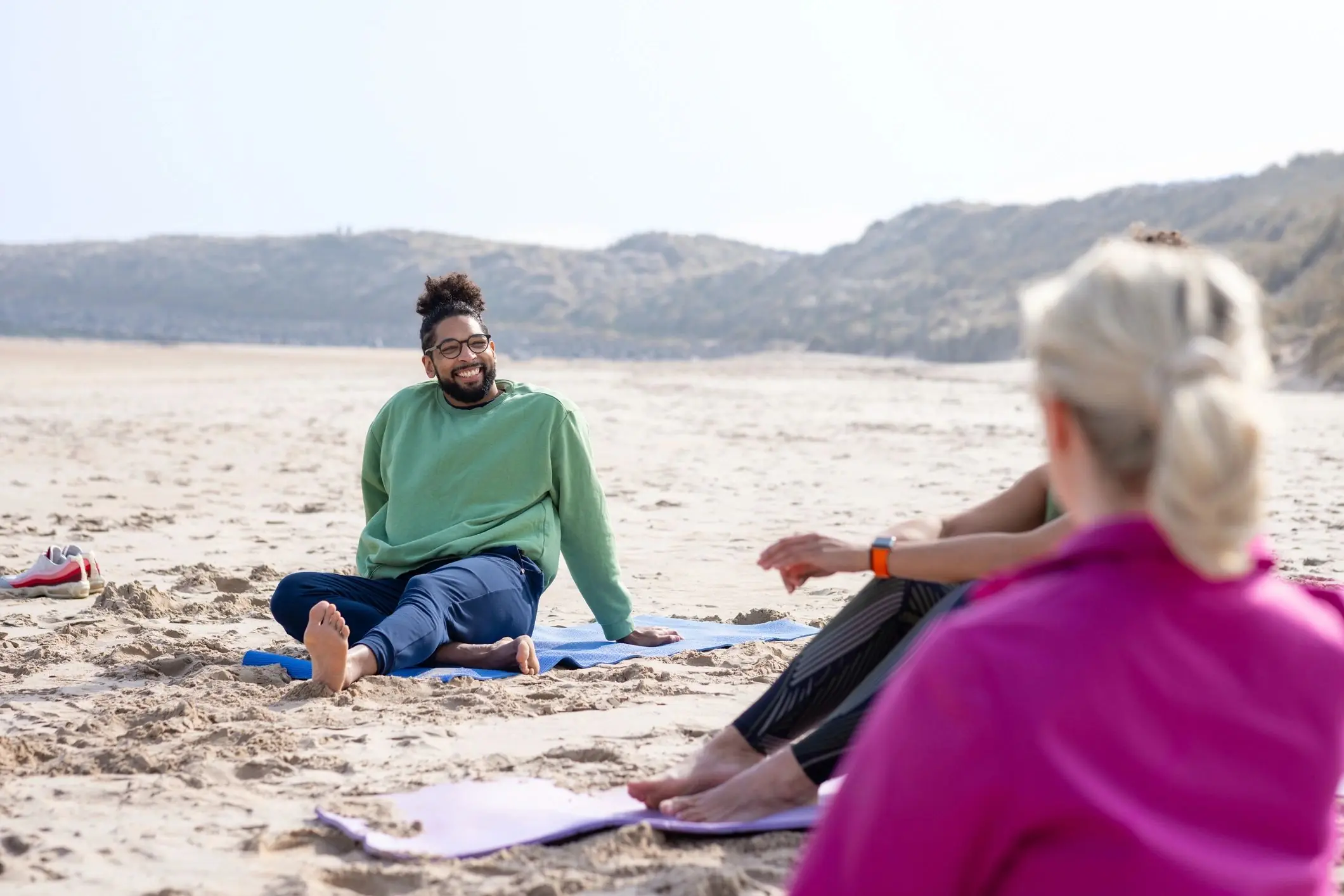 Group yoga session on a beach