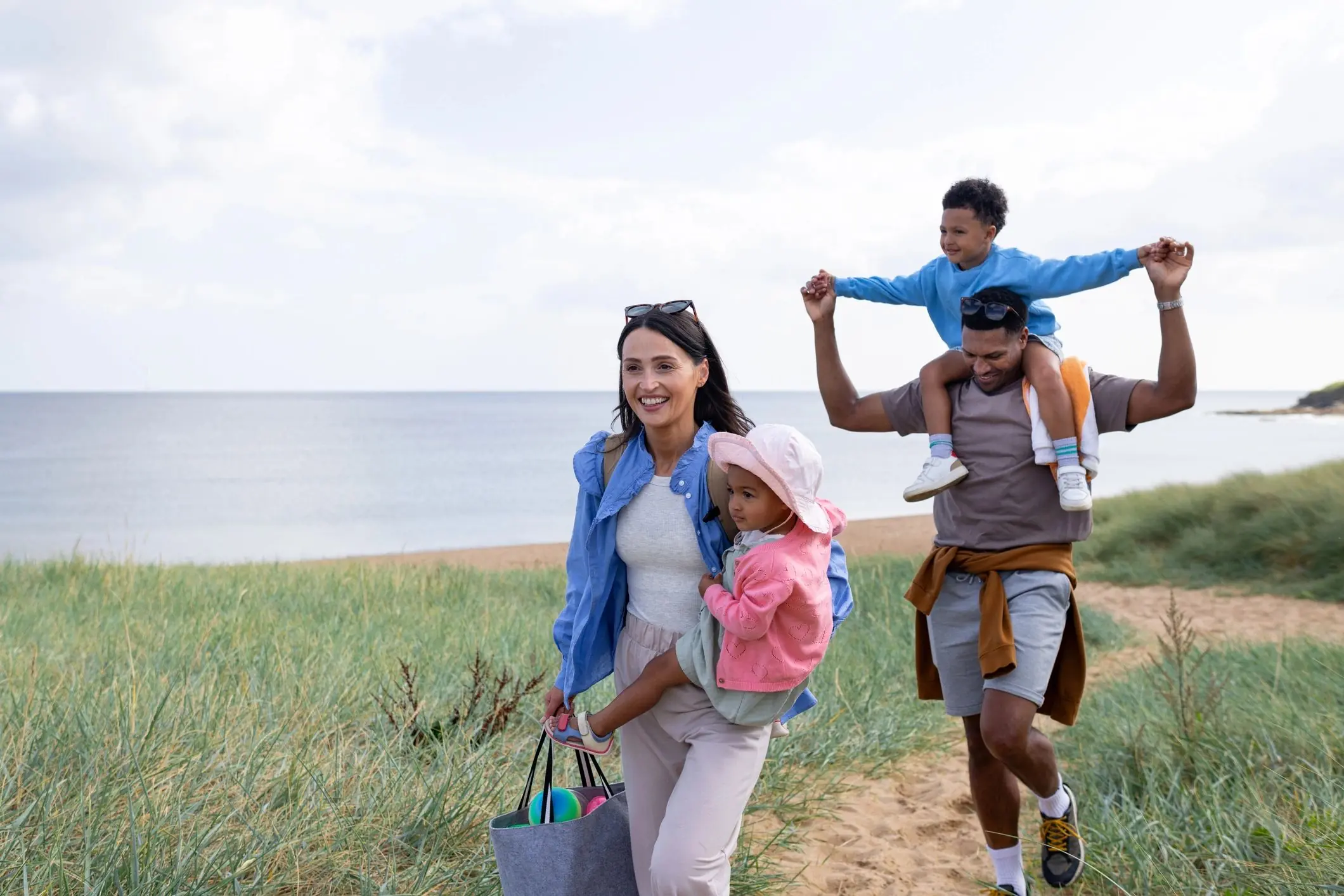 Family walking outdoors on a sandy path