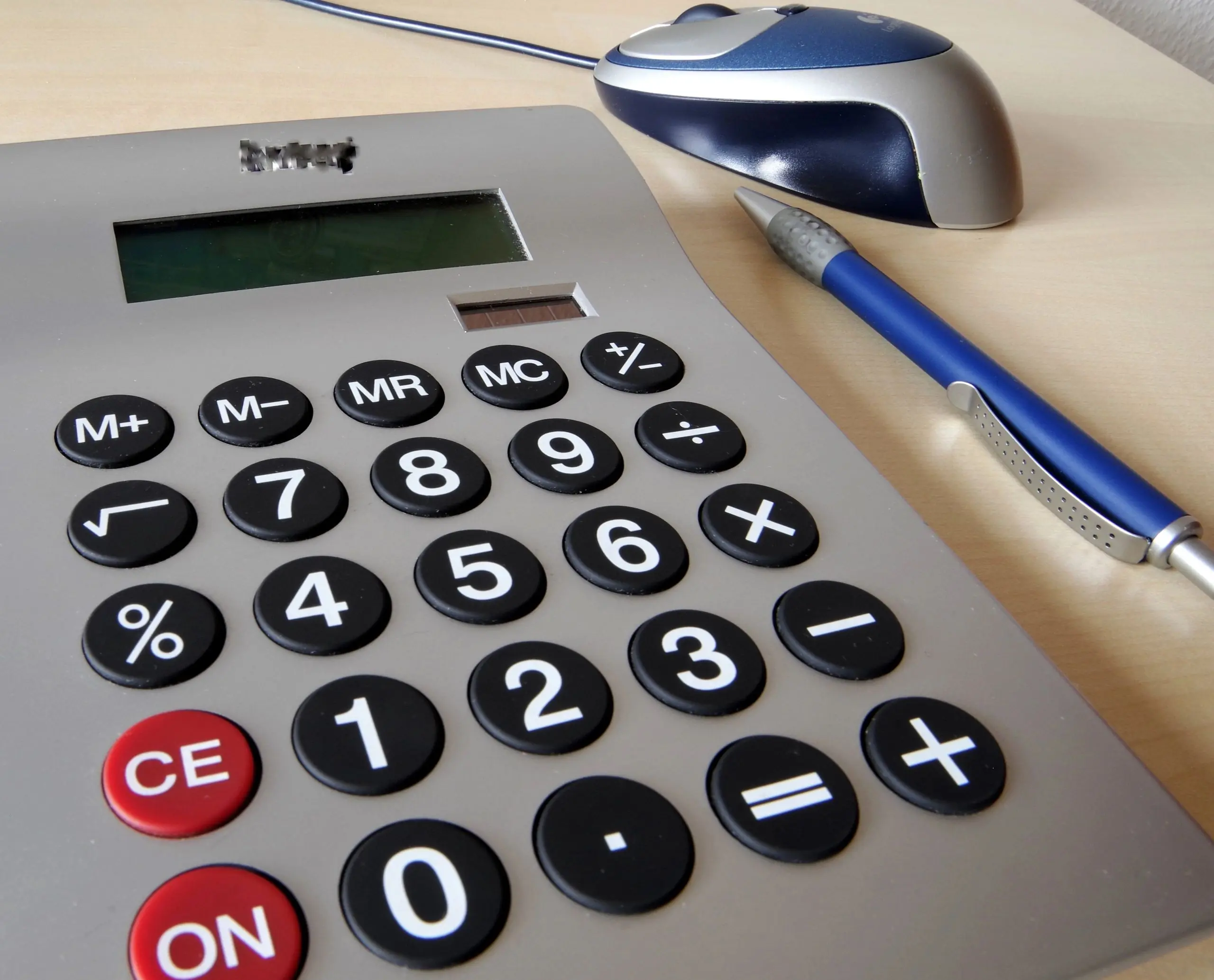 Calculator and pen for estimating an auto loan calculator payment
