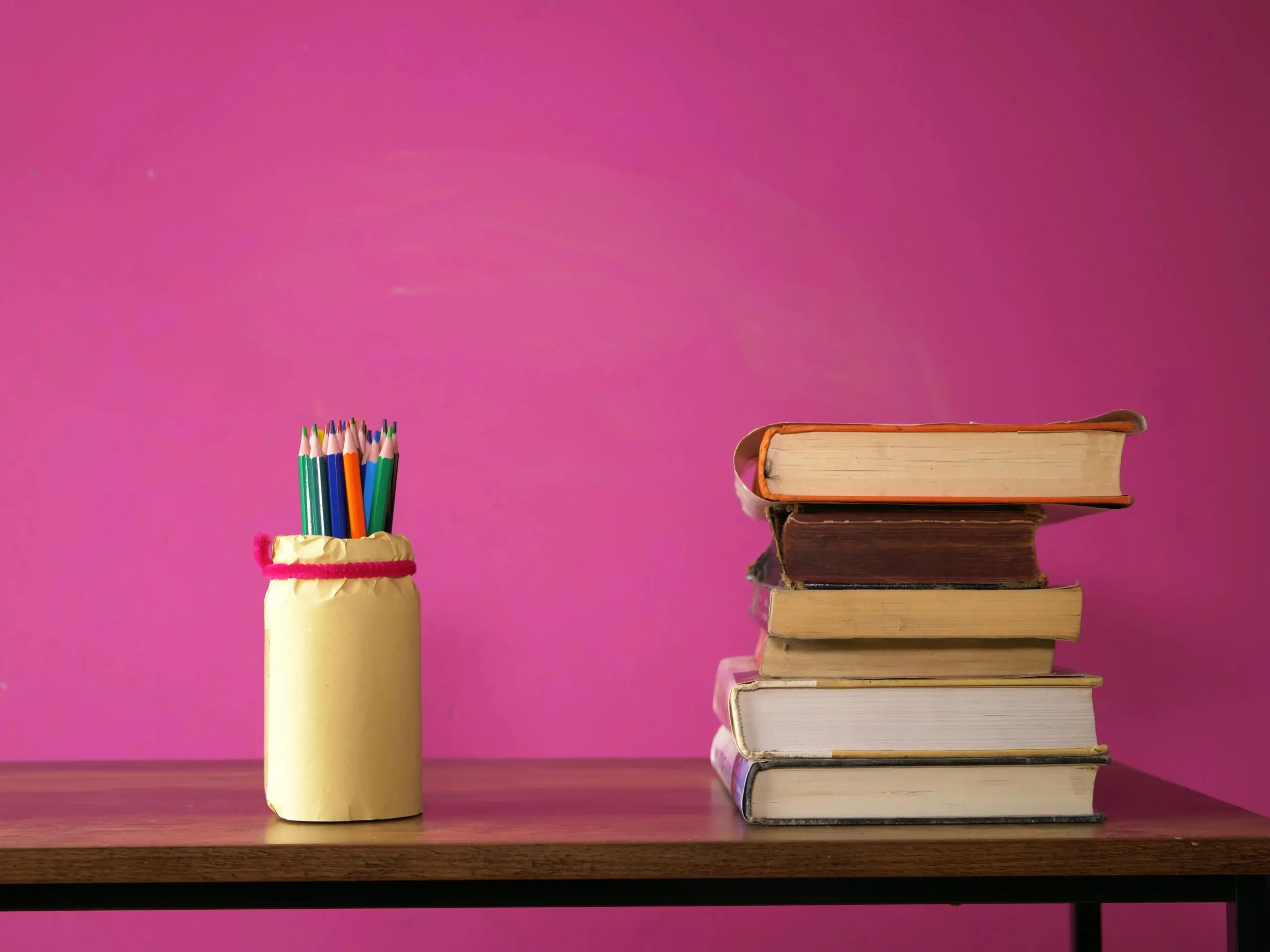 Books and pencils on teachers desk with copy space