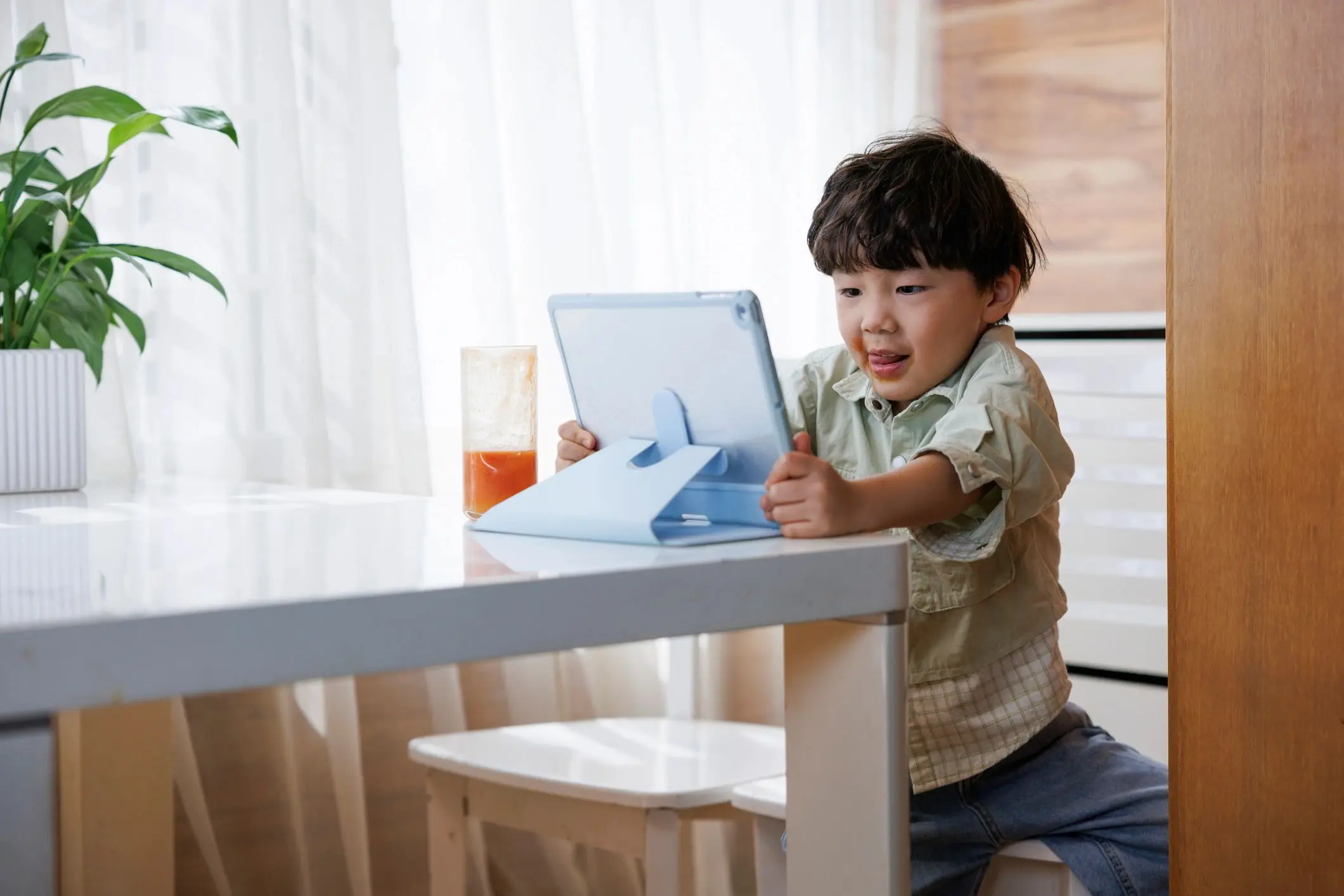 Child using tablet for learning and media