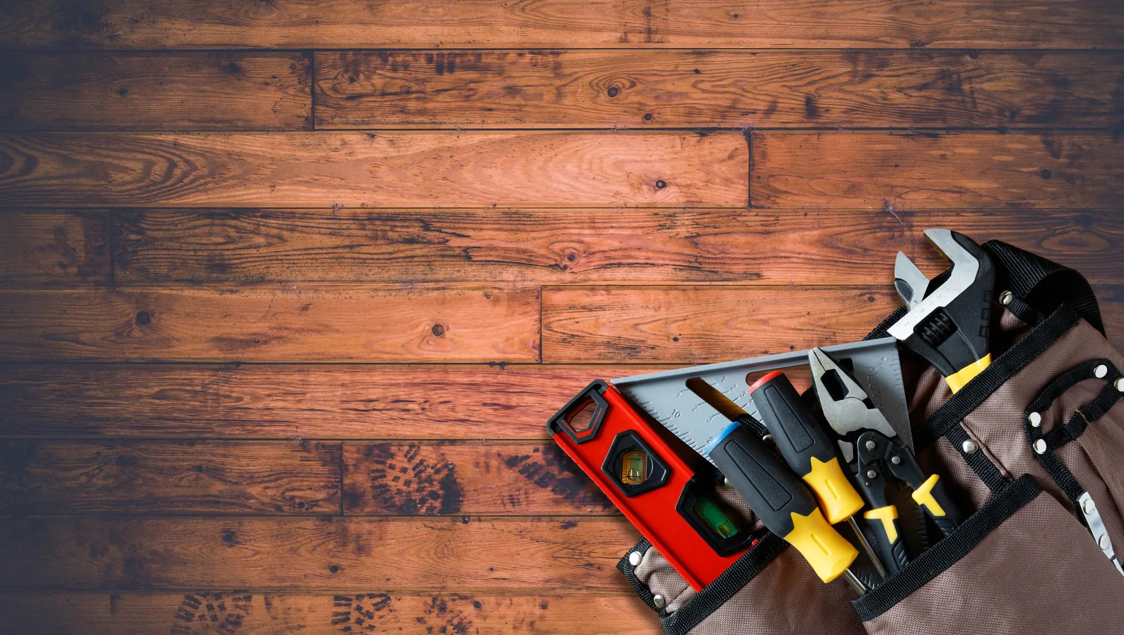Carpenter tools arranged on wood surface