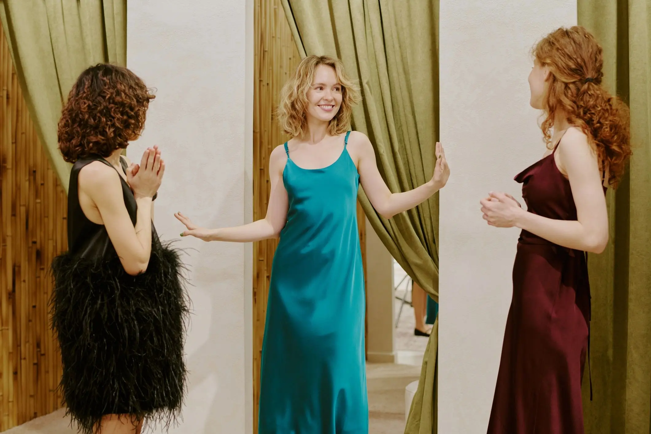 Friends comparing dresses in a clothing store